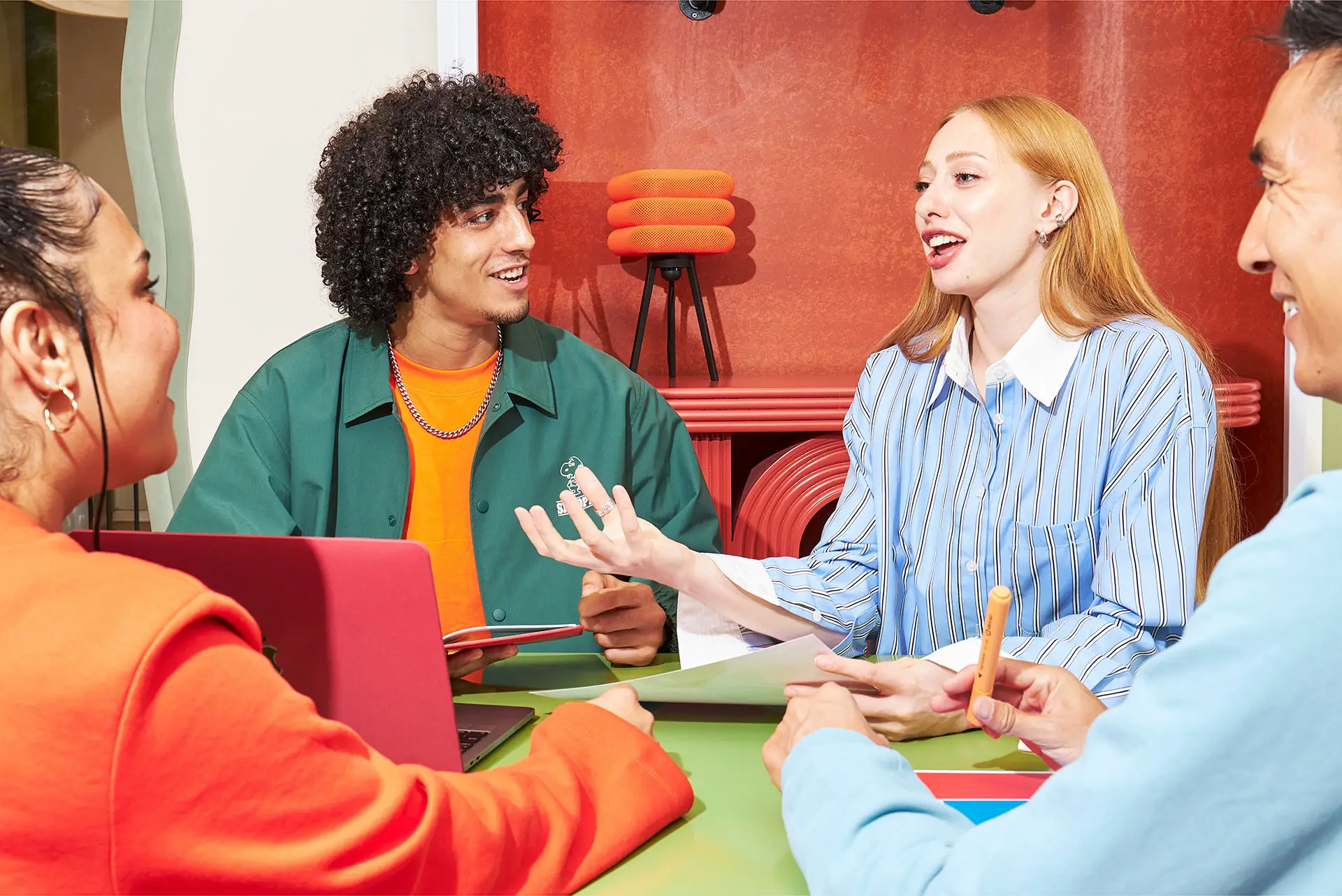 A small group of adults have a discussion around a table