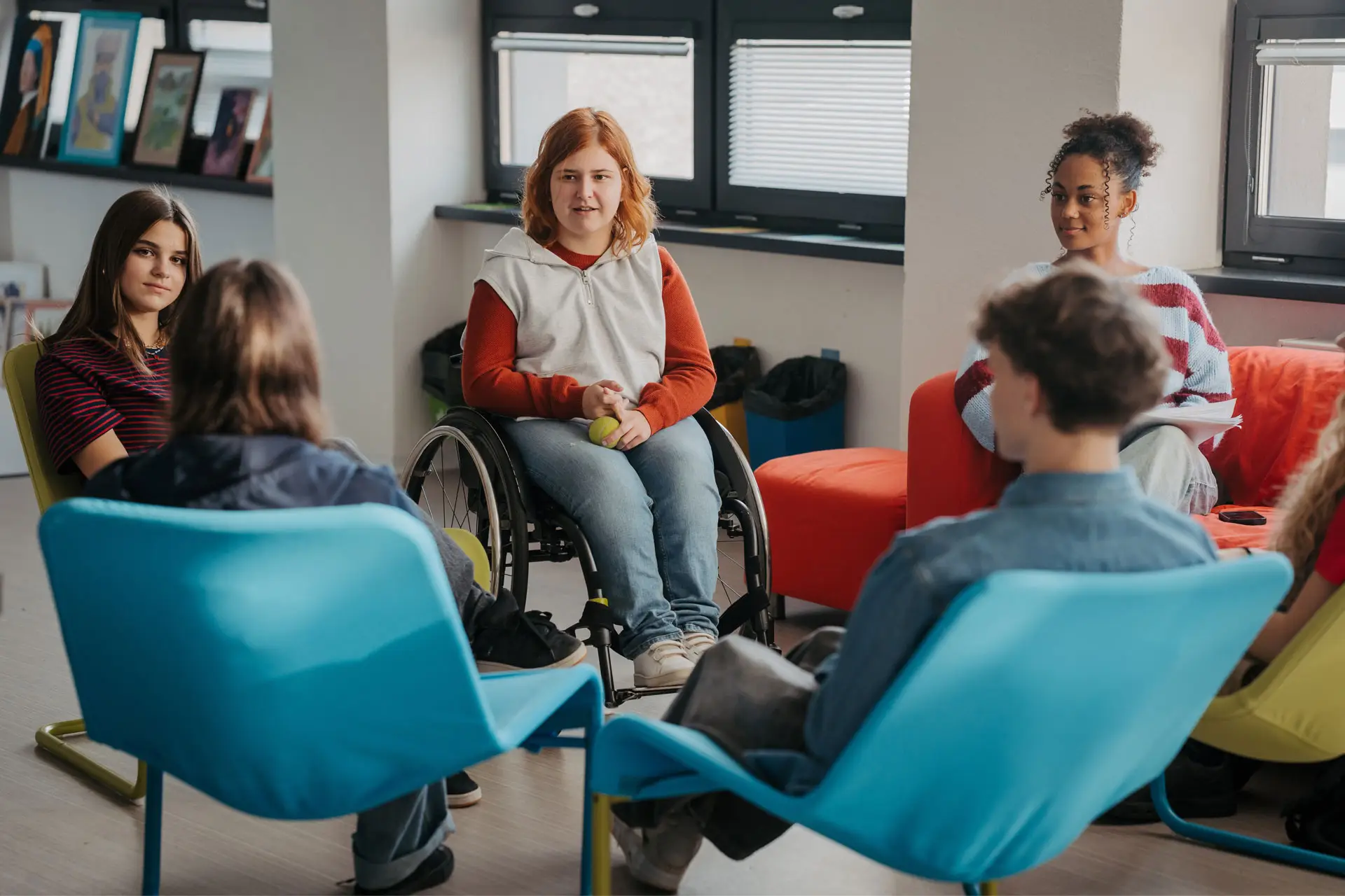 A diverse group of young adults has a group discussion